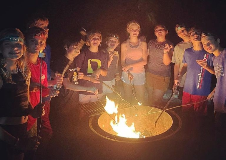 Discover the Adventure: Your Ultimate Guide to Camp Montana in Switzerland 1 A group of diverse campers laughing and enjoying outdoor activities at at Young Explorers Club