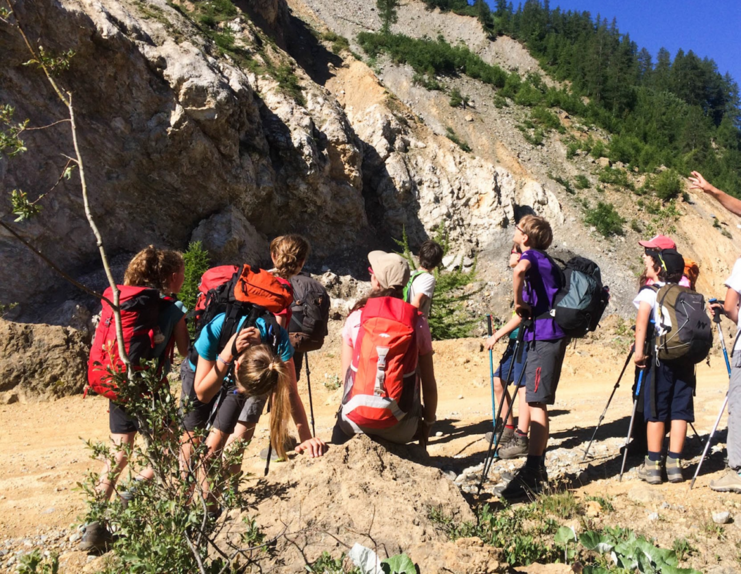 Explore the Best Summer Camps in Switzerland for an Unforgettable 2024 Adventure 3 Children participating in team building activities at a Young Explorers Club