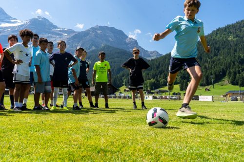 Young player kicking the ball during a Football Academy training session in the mountains