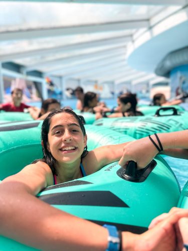 Teenager floating in an inflatable ring at the indoor water park