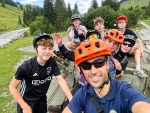 Instructor's selfie with teenage riders in bike helmets during the teen summer camp