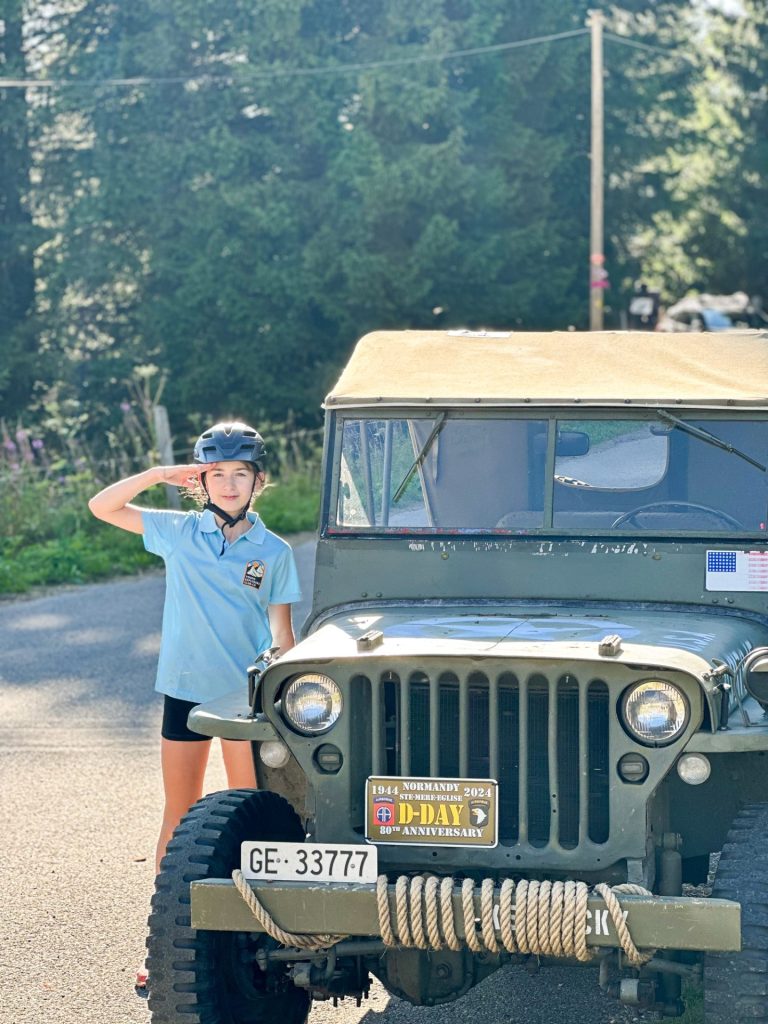 Camper saluting from the seat of a vintage Willys jeep