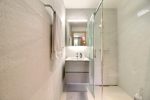 Modern bathroom with a glass shower and washbasin in the family camp chalet in Champéry
