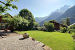 Garden lawn of the family camp chalet with the mountains around Champéry behind
